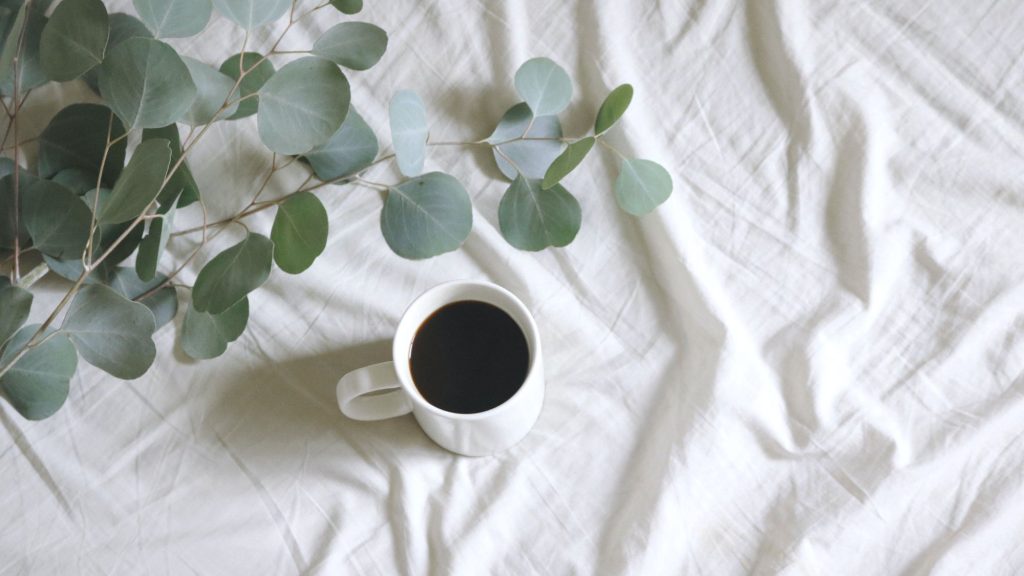 A cup of coffee on fresh cotton bedding; an endorsement for living room transformation