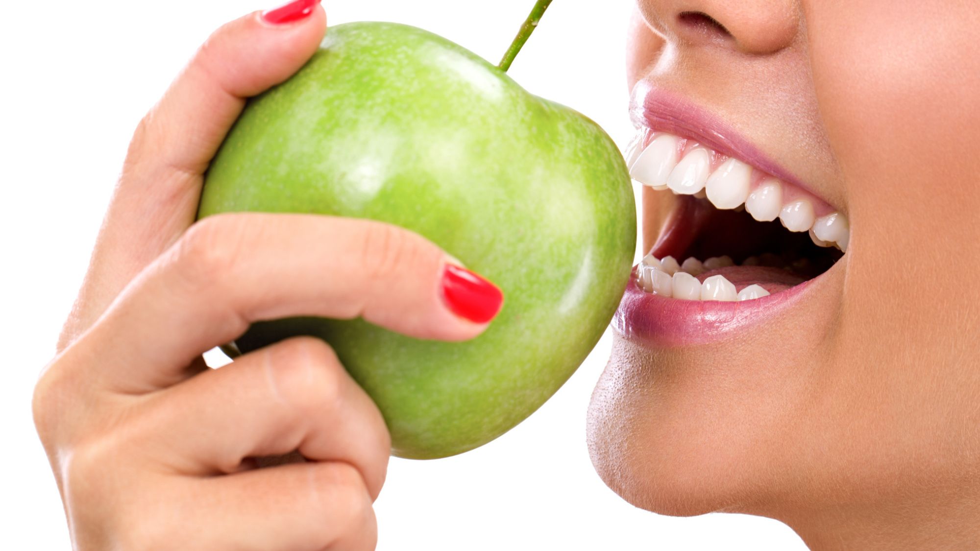 A girl eating green apple - picture related to connection between mouth larva and different oral parasites